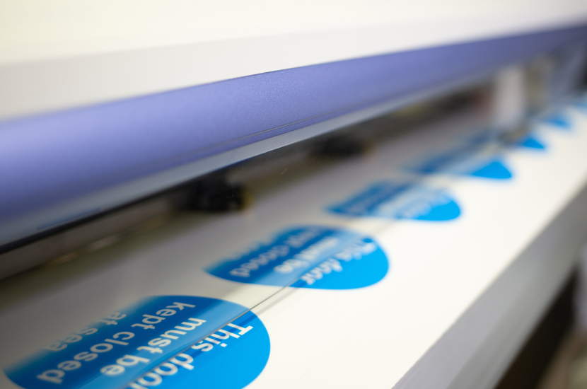Image of labels being printed on a wide format printer
